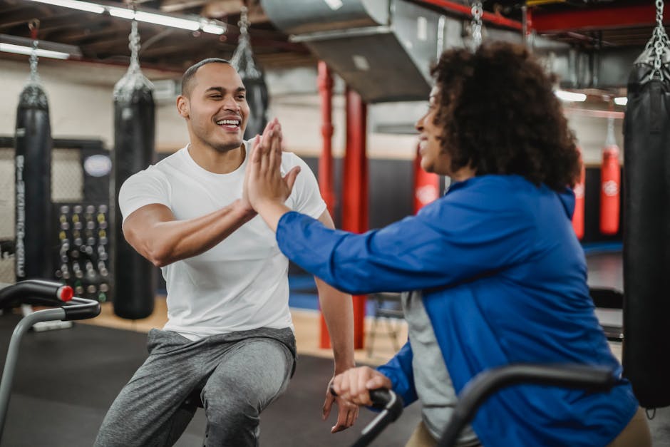A smiling online fitness coach and client giving each other a virtual high-five, symbolizing their compatibility and rapport.