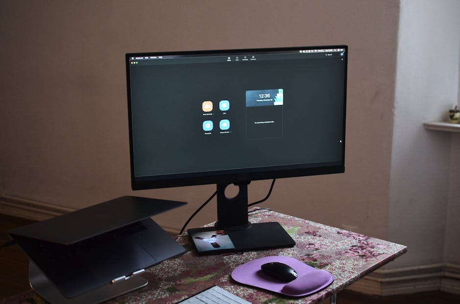 A desk with various data entry tools, including a computer, keyboard, and software programs displayed on the screen