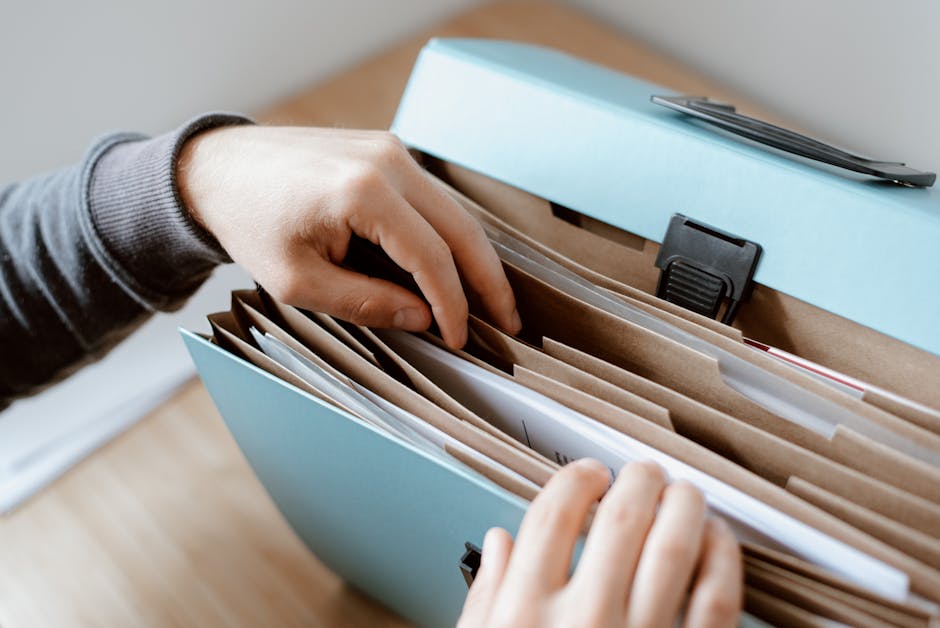 A person carefully examining various components of a job offer document