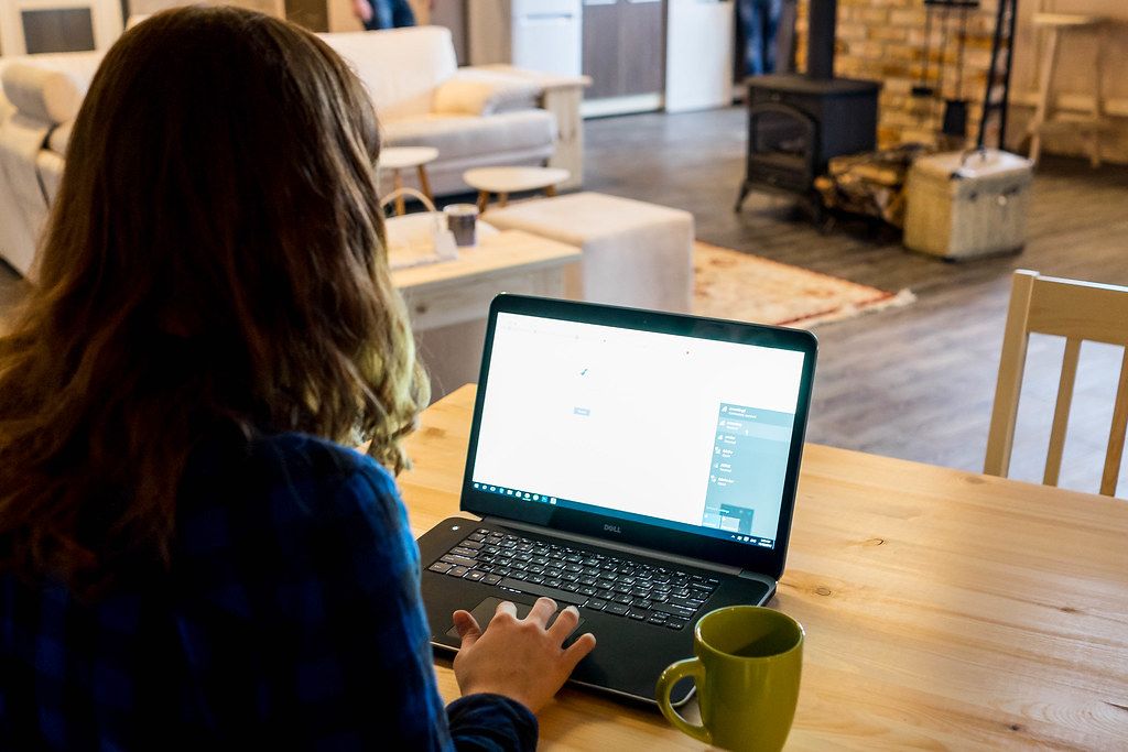 A freelancer working on a laptop in a comfortable home office setting