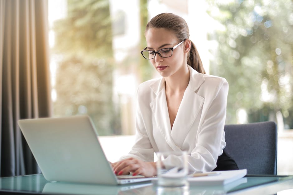 A professional carefully crafting a follow-up email on a computer