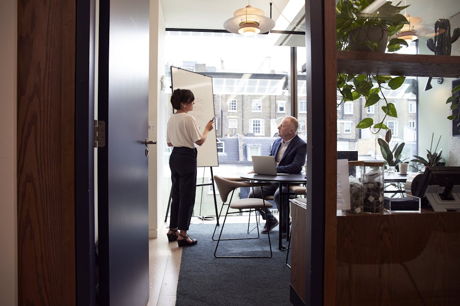 A professional delivering a concise elevator pitch to attentive listeners in an office setting