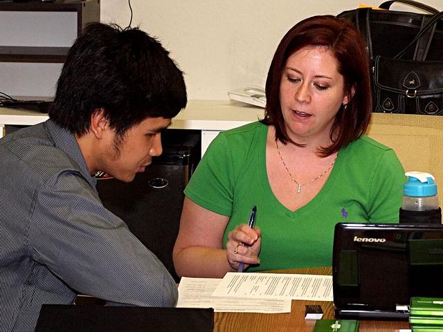 A person customizing their resume and cover letter to match a specific job description